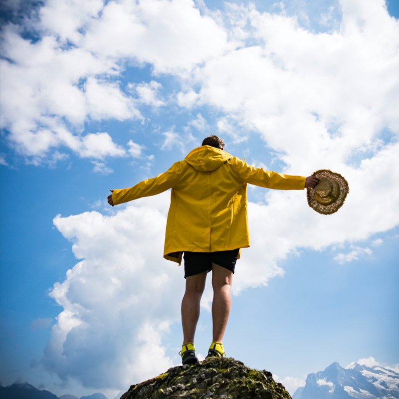 A Man standing on a Mountain Cliff