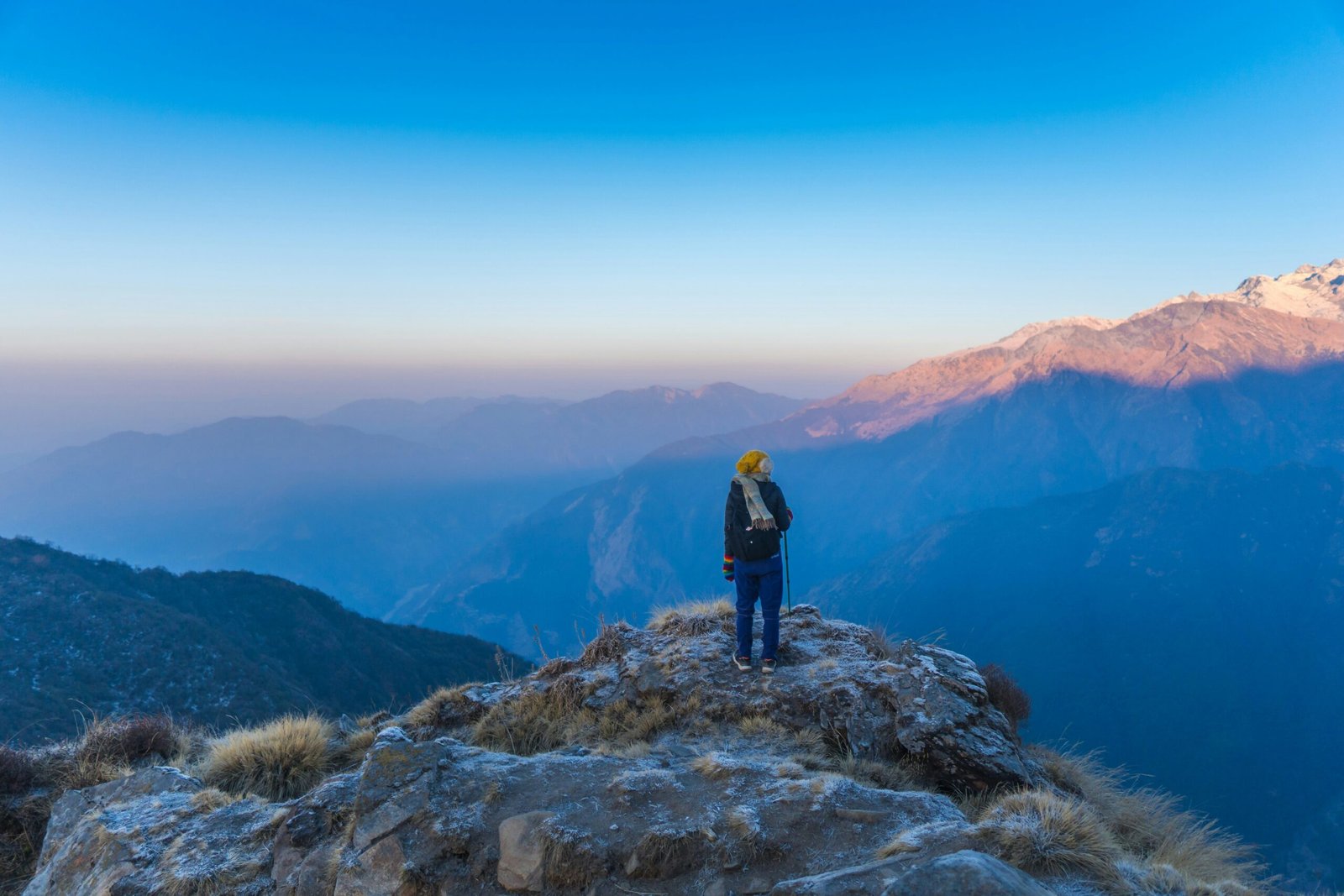 man standing on rock mountain during daytime